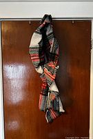 Scarf hanging showing length, pattern, and fringed edges