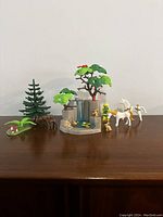Front view of the entire PLAYMOBIL Woodland Fairy set including fairies, unicorn, trees, rocky pond, and deer figures