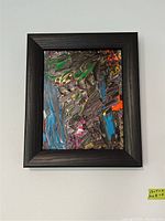 Frontal image showing the full abstract painting with vibrant colors and a thick black frame.