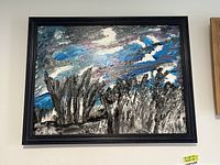 Framed original painting showing abstract winter storm scene with trees and sky in blues, whites, black, and gray.