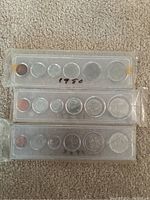 Photo showing three Canadian coin sets from years 1950, 1951, and 1952 each in plastic holder with 6 coins per set.