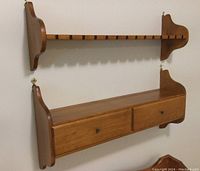 Photo showing both wood wall shelves mounted to a wall, highlighting the structure with slots on top shelf and drawers below.