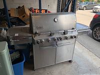 Front view of closed lid with control panel and storage cabinet below