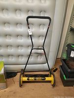 Front angle view of the Mac McCulloch 20-inch push reel lawn mower showing handlebar and cutting reel.