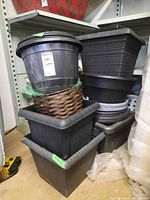Stacked black and brown plastic planters showing round and square shapes, with varying textures and sizes.