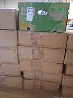 Stacked cardboard boxes labeled with model WL-301 containing recessed lighting housings.