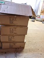 Five stacked cardboard boxes labeled WL-303-ICAT recessed lighting housings.