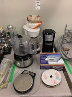 Photo of four kitchen small appliances including Hamilton Beach food processor/blender, Sunbeam coffee maker, Black & Decker coffee maker, and Salter electronic kitchen scale.