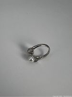 Silvertone ring with faux pearls and crystals, showing inner band marking and adjustable open style.