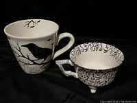 Two mugs on black background showing Halloween themes and chips