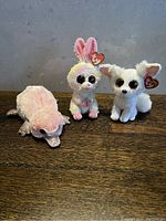 Front view showing the three TY plush toys standing side by side: platypus, rabbit, and dog