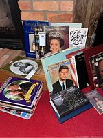 Photo showing a stack of books and magazines on royal family members including Queen Elizabeth II and Princess Diana, with titles clearly visible.