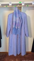 Full front view of light purple mohair coat with matching pastel colored scarf draped around collar.