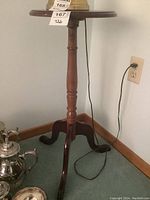 Photo of the small pedestal table showing round top and part of central column.