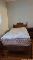 Full view of assembled bed with headboard, footboard, boxspring and mattress
