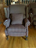 Front view of the wingback recliner chair with throw pillow