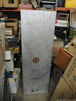 Full view of aluminum case standing upright with decal visible