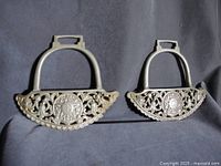 Front view of both stirrups showing decorative tread and frame