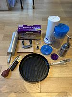 Photo showing assorted kitchen items including rolling pin, Kitchen bags box, grill pan, and ice tea maker