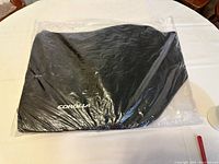 Black floor mat for 2020 Toyota Corolla Hybrid LE, sealed in original packaging, showing embroidered 'COROLLA' logo.