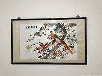 Framed Chinese silk embroidered artwork showing detailed bird and floral designs with inscription.
