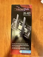 Photo of unopened Rocketfish 26-40 inch TV wall mount packaging showing product image and specifications.