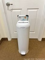 Full view of white Diaper Genie Platinum unit with two full refill boxes stacked on top.