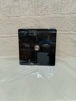 Front view of the black Withings Body+ smart digital scale showing reflective glass surface and circular sensor.