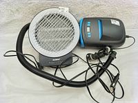 Mosquito killer with circular grill, light bulb inside and attached flexible hose, showing product brand BASEIN and model IKI-712AE.