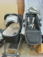 Full view of UPPAbaby Vista V2 stroller system showing bassinet on left and toddler seat on right, both attached to the stroller frame. The bassinet has a grey and whiteChevron interior pattern.