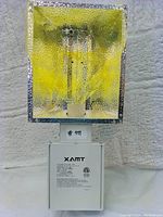 Front view of XAMT 315W grow light showing reflector and ballast housing with label.