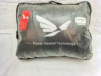 The packaging for the heated jacket showing Power Heated Technology logo and branding on a black carry bag.