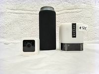 WYZE Cam, Bluetooth speaker, and digital timer grouped side by side on white background