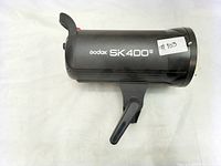 Side view of black Godox SK400II studio flash unit with branding.