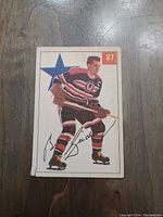 Front photo of 1954 Bill Gadsby Parkhurst hockey card showing player image, number 87, and signature.