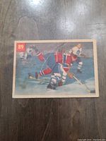 Front view of 1954 Parkhurst hockey card featuring Busher Curry in action on ice, showing card number 89 and visible creases and wear.