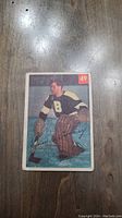 Front photo of the 1954 Jim Henry Parkhurst hockey card showing the player in Boston Bruins uniform, card number 49 in the corner.