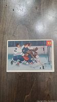 Front side of the 1954 Parkhurst Netminder's Nightmare hockey card #93 showing a hockey game scene with players in action near the goal.