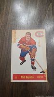 Front of Phil Goyette 1957 Parkhurst hockey rookie card, showing player in Canadiens uniform with stick, card number 11 and player name details.