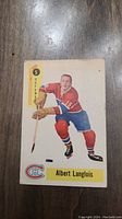 Front view of 1958 Parkhurst Albert Langlois rookie hockey card showing player image and team logo.