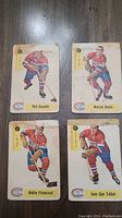 Four 1958 Parkhurst hockey cards featuring Montreal Canadiens players Phil Goyette, Marcel Bonin, Andre Pronovost, and Jean-Guy Talbot displayed front side showing player images and team logo.