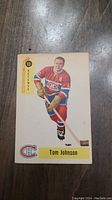 Front side of 1958 Tom Johnson Parkhurst hockey card showing player image, position, team logo, and name.