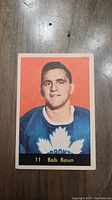 Front of 1961 Bob Baun Parkhurst hockey card showing player portrait and name.