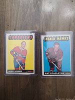 Front view of two hockey cards: Jacques Laperriere Canadiens and Pat Stapleton Black Hawks in plastic protectors.