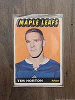 Front of 1965 OPC Tim Horton hockey card with Maple Leafs logo and player image.