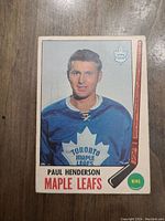 Front view of 1969 Paul Henderson OPC hockey card in Maple Leafs uniform with graphics and player info on front.