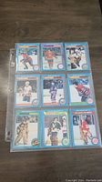 Front view of 9 1979 OPC hockey cards placed in a protective sleeve showing players from different teams.