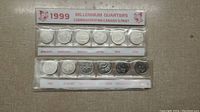 Front view of the 1999 Millennium Quarters with months January to June in plastic packaging showing commemorative header.