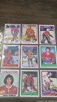 Front side of 9 Montreal Canadiens hockey cards showing player images including Guy Lafleur, Richard Sevigny, Rick Wamsley, Larry Robinson, Mario Tremblay, Doug Soetert and others.