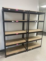 Two assembled 5-tier shelving units side by side against wall